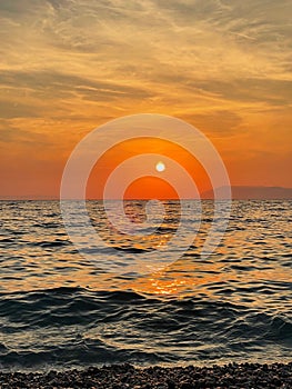 Scenic sunset over a calm seascape outdoors