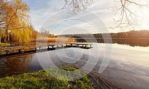 Scenic sunset with a pier on a lake near the town of Recz, West Pomeranian Voivodeship, Poland