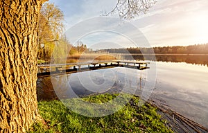 Scenic sunset with a pier on a lake near the town of Recz, West Pomeranian Voivodeship, Poland