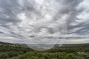 Scenic Tajuna valley under a dark gray sky, dotted with asperitas clouds photo
