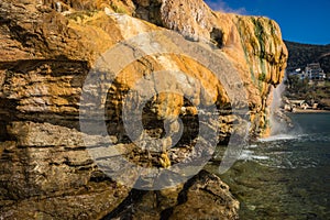 Scenic thermal waterfalls on beach in Loutro Edipsou, Evia, Gr