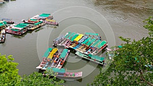 Scenic tourist boats on Narmada river against the backdrop of omkareshwar Temple.