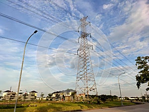 A scenic tranquil of A transmission tower with its electriciy cables, under the blue sky.