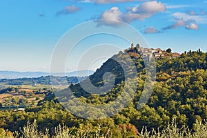 Scenic Tuscan landscape with small village on top of hill