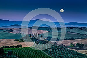 Scenic Tuscany landscape in moonlight at dawn, Val d'Orcia, Italy