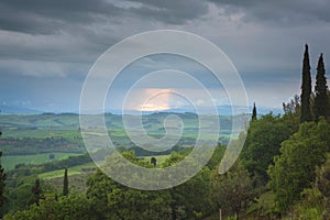 Scenic Tuscany landscape panorama with rolling hills and harvest fields in golden morning light