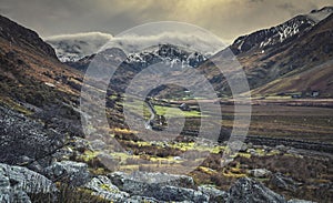 Scenic Valley at Winter with Cloud Capped Peaks of Mountains