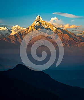 Scenic vertical photo of Fish Tail mountain peak also known as Machapuchare during sunrise in the Himalayas