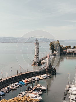 Scenic vertical view of boats at the harbor entrance of Lindau at lake Constance in Germany