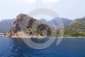 Scenic view of the Aegean Islands. The unique shades of the sea and the rocks covered with pine trees