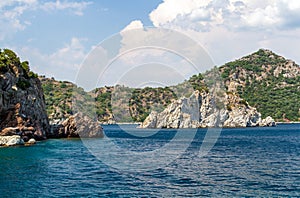 Scenic view of the Aegean Islands. The unique shades of the sea and the rocks covered with pine trees