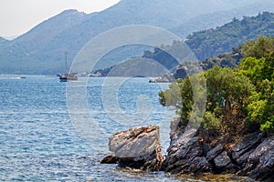 Scenic view of the Aegean Islands. The unique shades of the sea and the rocks covered with pine trees