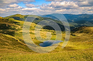 Scenic view of Apshynets glacial lake and Svydovets mountain range at sunny summer day, Ukrainain Carpathian Mountains