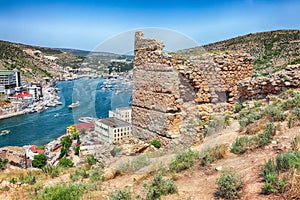 Scenic view of Balaklava bay with yachts and ruines of Genoese fortress Chembalo in Sevastopol city from the height