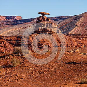 Scenic view of the barren landscape of Mexican Hat Rock in Utah, USA on a sunny day