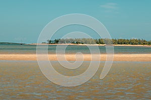 Scenic view of beach against blue sky at the Manda Island in Lamu Island UNESCO World Heritage Site in Kenya