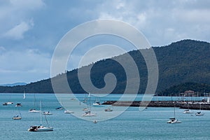 Scenic view of a beach with multiple small boats harbored on the coast