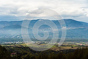 A scenic view of beautiful clouds in the sky over mountain valley