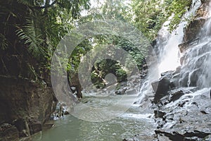 scenic view of beautiful Kanto Lampo Waterfall, green plants and rocks,