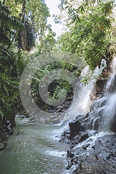 scenic view of beautiful Kanto Lampo Waterfall, green plants and rocks,