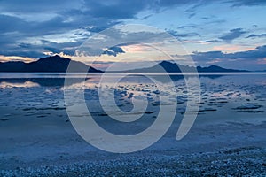Scenic view of beautiful mountains reflecting in lake of Bonneville Salt Flats at sunset, Wendover, Western Utah, USA, America.
