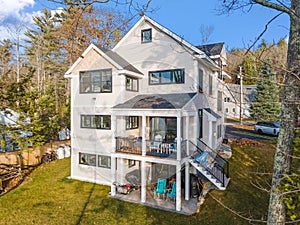 Scenic view of a beautiful white modern house near the lake on a sunny day