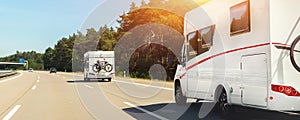 Scenic view big modern white family rv camper van vehicle driving on european highway road against blue sky in summer