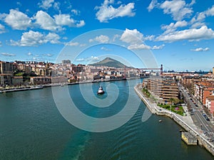 Scenic view of a blue river flowing through the vibrant cityscape of Bilbao, Spain