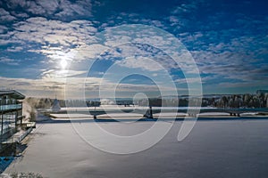 Scenic view of bridge over frozen Ume river in Lycksele, Northern Sweden. Frozen river covered by fresh fallen snow, winter Sun in