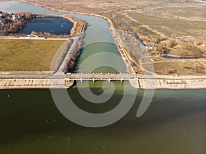 Scenic view of a bridge spanning a wide expanse of green water