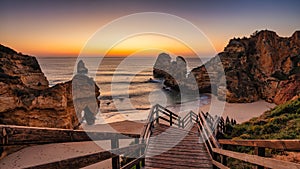 Scenic view of Camilo beach with a set of steps leading down to sandy shoreline at sunrise