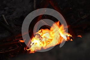 Scenic view of a campfire with glowing yellow flames