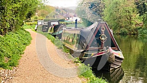 Scenic view of canal boat and picturesque waterway, surrounded by lush greenery and quaint countryside in Apsley