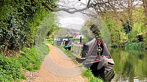 Scenic view of canal boat and picturesque waterway, surrounded by lush greenery and quaint countryside in Apsley