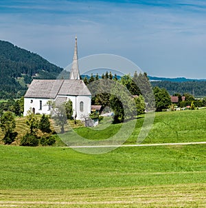 Scenic view of a chapel and green hills over the German countryside in the village Kappel