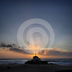 Scenic view of the church on the beach against sky during sunset near Porto, Portugal, January 2018