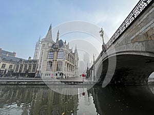 Scenic view of the city of Ghent Belgium with bridge and canal in the morning mist