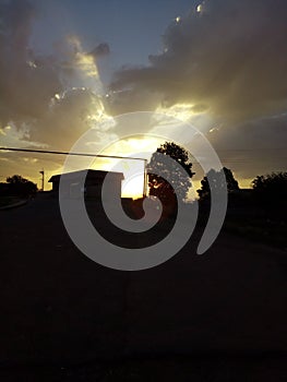 Scenic view of a cloudy sunset in a rural area in silhouette