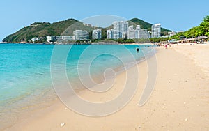 Scenic view of Dadonghai white sand beach with blue sky and Luhuitou peninsula view in Sanya Hainan island China