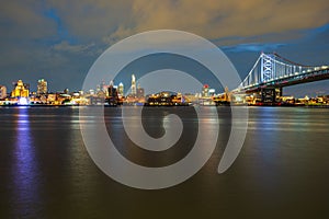 Scenic view of downtown Philadelphia on the bank of river Delaware with Ben Franklin Bridge at night