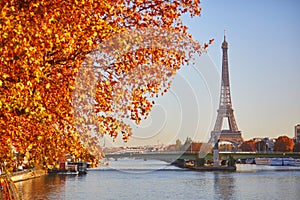 Scenic view of the Eiffel tower over the river Seine from Mirabeau bridge on a bright fall day in Paris