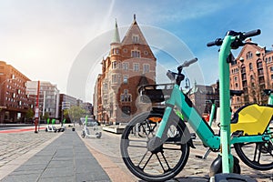 Scenic view electric rental bicycle bikes parked St. Annenplatz in old Hafencity Speicherstadt quartier haven Hanburg