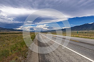 Scenic view of an empty road with mountains on the background, in the State of Colorado