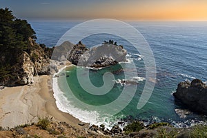 Scenic view of the famous McWay Falls on a beautiful sunny day with blue sky in summer, Julia Pfeiffer Burns State Park, Big Sur