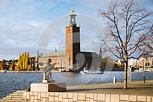 Stockholm city hall with Djurgarden ferry boat and Evert Taube statue, Sweden, Scandinavia photo
