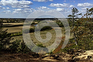 Scenic view of farm fields and a creek with a cloudy sky photo