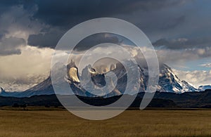 Scenic view of a field against mountain landscape in Torres del Paine National Park, Chile