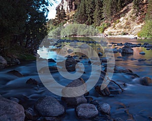 Scenic view of the flow of a river with trees alongside