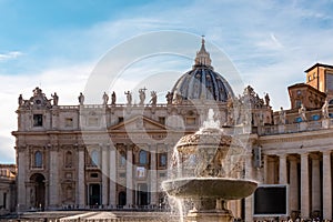 Rome - Scenic view on the fountain on St Peter square with Saint Peter Basilica in the Vatican City, Rome