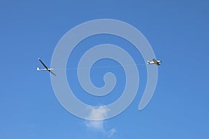 Scenic view of a Glider is pulled up to altitude by a powered aircraft